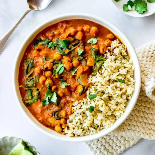 One-Pot Chickpea Curry with spinach served in a bowl, garnished with fresh cilantro.