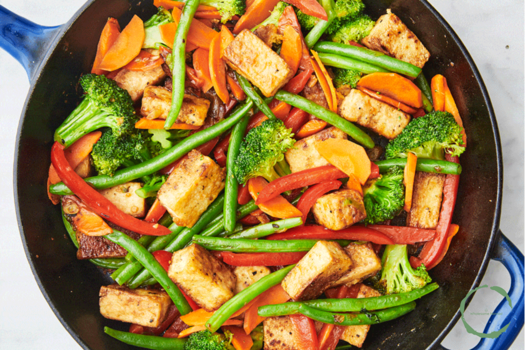 Asian Vegetable Stir-Fry with crispy tofu, broccoli, bell peppers, and carrots served over rice.